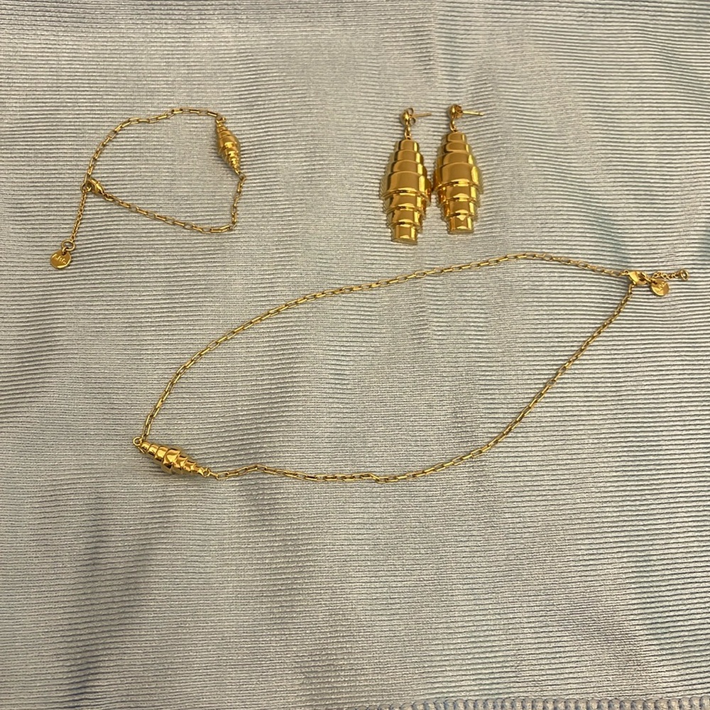 APC jewlery set- necklace, bracelet, and earrings. Gold